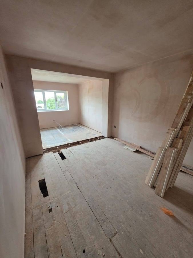 The same room plastered out, walls and ceiling flat and ready to decorate