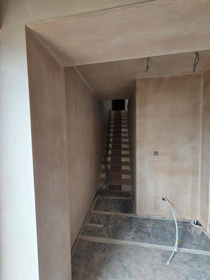 The same stairwell plastered from top to bottom
