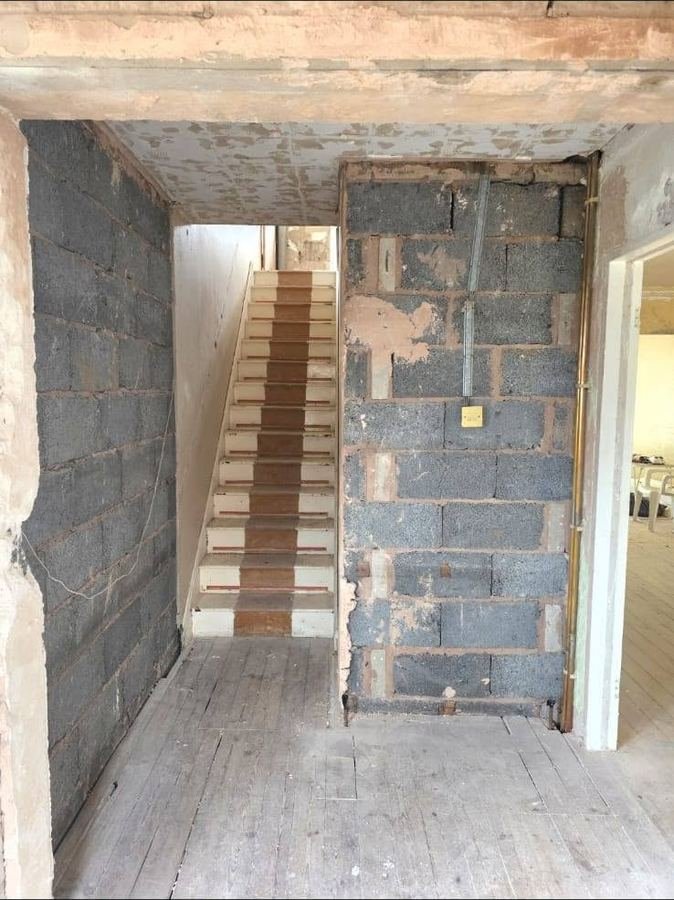 A stairwell in bare blockwork with the staircase in place